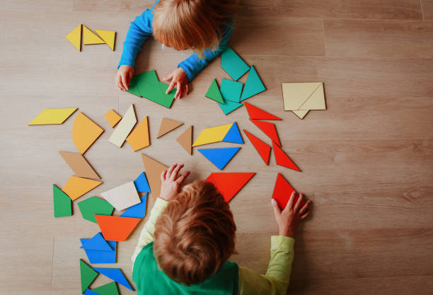 little boy and girl playing with puzzle, education concept